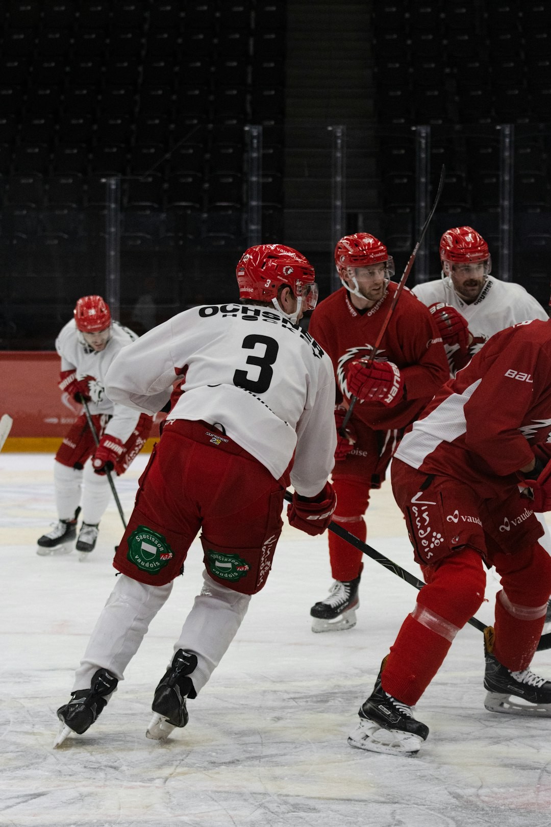 a group of men playing a game of ice hockey